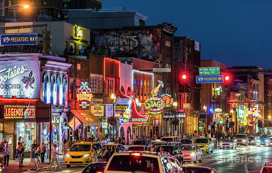 Broadway in Nashville at night with neon honky-tonk signs